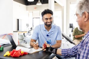 Clinician working with a man on therapy