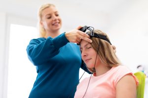 woman using BTE machine to do therapy