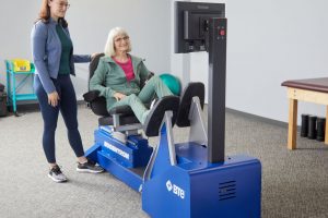 clinician helping a male patient do exercises