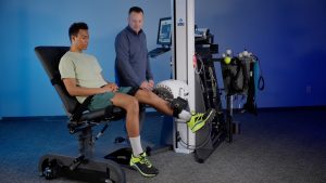 Patient performs functional rehab exercise on PrimusRS, seated knee extension