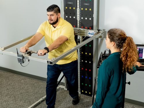 Injured worker performing a functional capacity evaluation in physical therapy